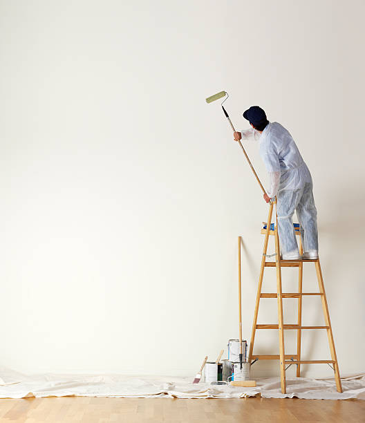 Professional painter applying fresh coat of paint in Triad NC